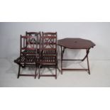 A folding wooden octagonal garden table with four chairs