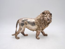 A silver plated figure of a lion, with indistinct marks - length 30cm, height 21cm