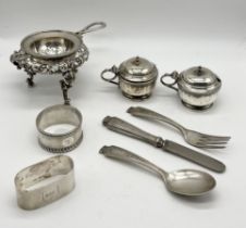 A collection of hallmarked silver including mustard pots, cutlery, serviette rings and a tea