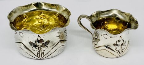 A hallmarked silver cream jug and sugar bowl with floral decoration, weight 64.3g