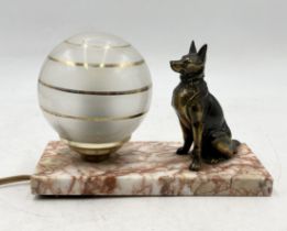 An Art Deco lamp with seated dog and globular shade on marble base