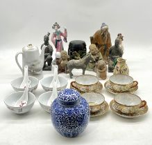 An assortment of oriental figurines, bowls, cups etc