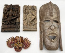 A collection of carved Eastern and African masks and deities