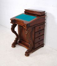 A reproduction mahogany davenport, with green baize inset top to reveal a fitted interior, with