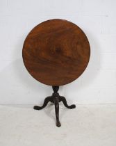 A Georgian mahogany circular tilt-top tripod table, with hoof feet - diameter 74cm, height 71cm