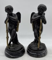 A pair of bronze Cupid figures resting on their bows- signed to base L J Moreau, 23cm height