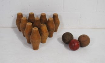 A vintage set of ten wooden skittles and three balls