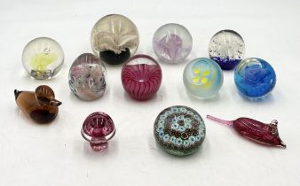 A collection of glass paperweights including millefiori example etc.