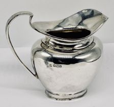 A hallmarked silver cream jug, weight 179.8g