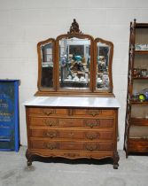 A French oak marble topped dressing chest of five drawers, with large adjustable bevel-edged mirror,