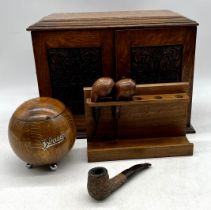 A vintage smokers cabinet along with a selection of pipes, tobacco jar etc