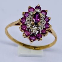 A ruby and diamond cluster ring set in 9ct gold, size R