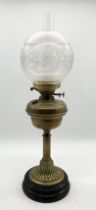 An early 20th century oil lamp with globular shade on ceramic base