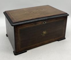 A turn of the century Swiss musical box in rosewood case with inlaid detail to the lid and front