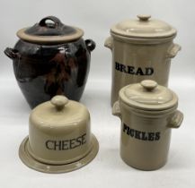 A collection of salt glazed pottery including bread bin, pickle jar, cheese dome and large lidded