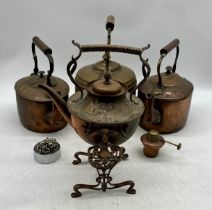 An Art Nouveau spirit kettle and stand along with three vintage copper kettles etc