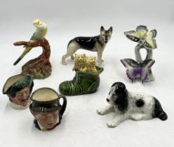A collection of ceramics including Wade budgerigar, Sylvac spaniel, Royal Doulton Toby jugs etc.