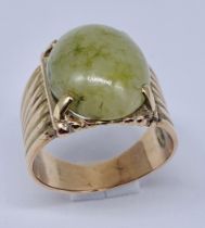 An unmarked 9ct gold (tested) ring set with jade, size P, weight 7.7g