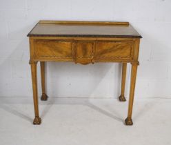 A turn of the century painted side table, with single drawer, with carved detailing, raised on