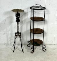 A wrought iron plant stand (height 87cm) along with a large wrought iron candle stick.