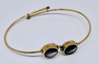 An unmarked 9ct gold bracelet with unusual interlocking sections, total weight including stones 7.