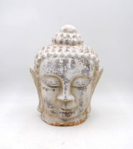 A weathered painted terracotta Buddha head - height 37cm