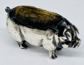 A hallmarked silver pincushion in the form of a pig