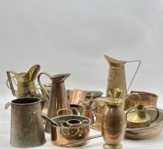 An assortment of brass and copper jugs etc