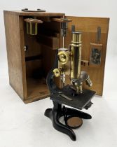 A cased early 20th century microscope by E. Leitz, Wetzlar (serial No. 124778) with several lenses