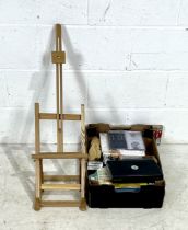 A desk top easel along with a selection of art materials chalks, pencils, sketch pads, canvases,