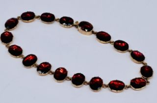 A 9ct gold bracelet set with garnet coloured stones