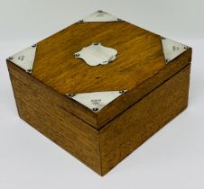 An oak silver mounted box with vacant cartouche