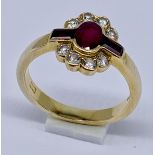 A ruby and diamond cluster ring set in 18ct gold, size M