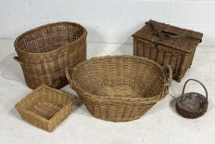 A collection of wicker baskets including a fishing basket