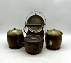 A vintage copper kettle, two biscuit barrels and a two-tier folding metal cake stand