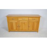 A modern oak sideboard, with three drawers and cupboards under - length 160cm, depth 42.5cm,