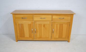 A modern oak sideboard, with three drawers and cupboards under - length 160cm, depth 42.5cm,