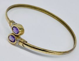 A 9ct gold bangle set with amethysts and diamonds, total weight 6.9g