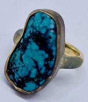 A 9ct gold ring set with a large irregular turquoise, size P 1/2