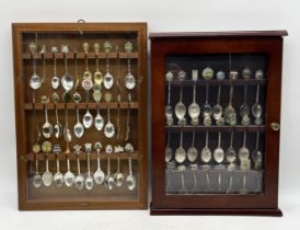 A collection of souvenir teaspoons in display cases