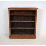 An oak freestanding four tier bookcase - length 101cm, depth 29.5cm, height 117cm