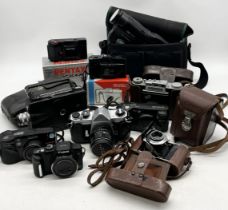 A collection of various vintage cameras including Pentax PC35, Pentax Asahi Spotmatic, Prontor II,