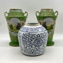 A pair of oriental vases, repaired crack to one handle along with a ginger jar.