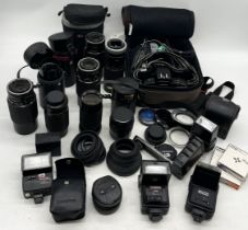 A collection of cameras, lenses and accessories including Canon, Vivitar etc.