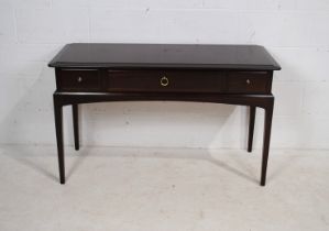 A Stag side table, with three drawers, raised on tapering legs - length 120cm, depth 46.5cm,