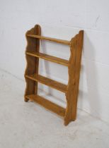 A pine four tier wall hanging shelf - length 51.5cm, height 71cm