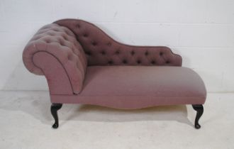 A modern chaise longue of small proportions, with button-back detailing, raised on cabriole legs -