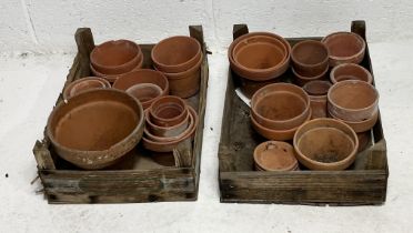 A collection of terracotta pots in two boxes