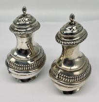 A pair of hallmarked silver pepperettes
