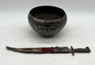 An Eastern brass bowl with inlaid silver detail along with a brass dagger